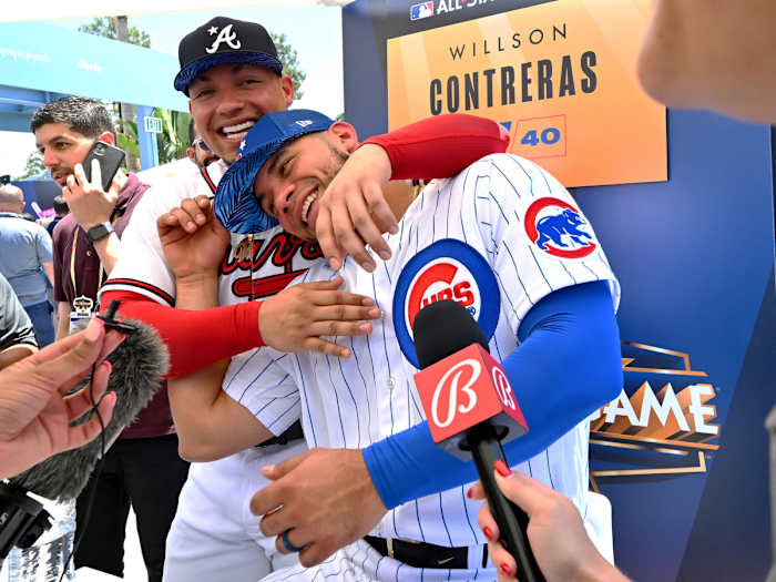 Jul 18, 2022; Los Angeles, CA, USA;  Chicago Cubs catcher Willson Contreras (40) is interviewed as his brother, Atlanta Braves designated hitter William Contreras (24) sneaks up behind him at All Star-Media Day at Dodger Stadium.